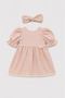 Powder-Colored Baby Dress with Tie-Back and Scalloped Hem.