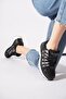 Vakos women's black sneakers with side stripe detail