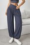 Women's high-waisted, wide-leg viscose pants with drawstring waist and pockets.