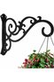 Black hanging plant stand with wall-mounted iron hooks for outdoor flower pot decoration.