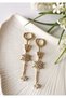 Gold celeste star detailed steel dangle earrings 1.5x7 cm
