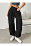 Women's high-waisted, wide-leg viscose pants with drawstring waist and pockets.