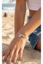 Silver-colored, white enamel, evil eye bead, elephant-themed brand and model bracelet.