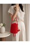 Red Hand-Knitted Bucket Bag – Drawstring Shoulder Bag with Gold Charm Detail