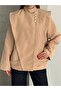 High Collar, Asymmetrical Button Detail, and Flounce/Ruffle Appearance on the Shoulders