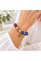 Colorful Beaded Peace Symbol Bracelet – Stylish Accessory with Gold Detailing and Patterned Design