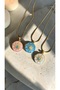 Pink - Oval Pendant Necklace with a Sun-Shaped Design and Stone Embellishments in the Center.