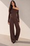 Blouse with an asymmetric neckline, long sleeves, and one shoulder exposed. Long pants with elastic waist.
