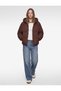 Long-Sleeved Anorak Puffer Jacket with Zipper and Hood, Featuring Pockets.