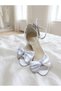 Evening dress shoes with a white bow detail, glittery sand-colored design, single-strap construction, and high heels - 6