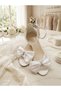 Evening dress shoes with a white bow detail, glittery sand-colored design, single-strap construction, and high heels - 2