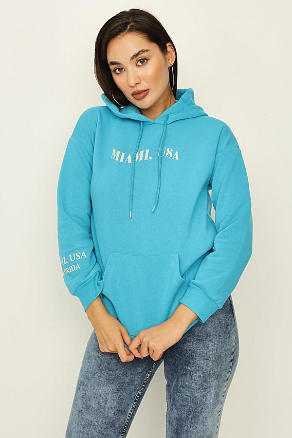 Select Moda Women s Turquoise Hooded Sweatshirt with Text Detail on the Back Trendyol
