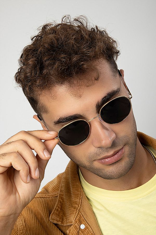 Young Man with brown curly hair, wearing round sunglasses