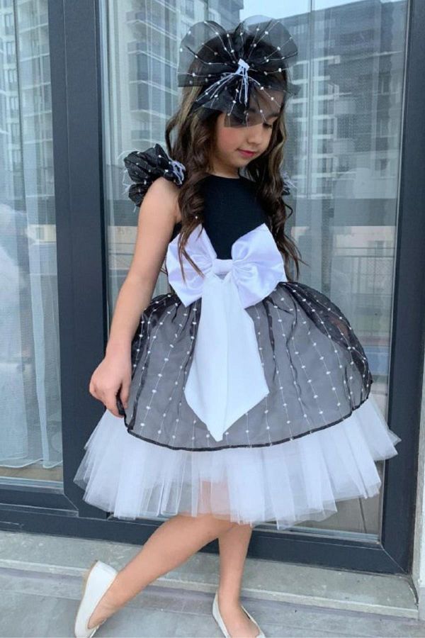 Riccotarz Girl s Black and White Evening Dress with Ribbon Waist Fluffy Tulle Skirt and Ruffle Sleeves Trendyol