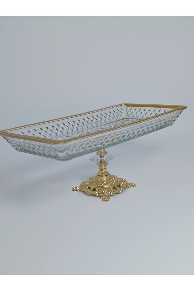 Gold-plated metal serving plate with stand.