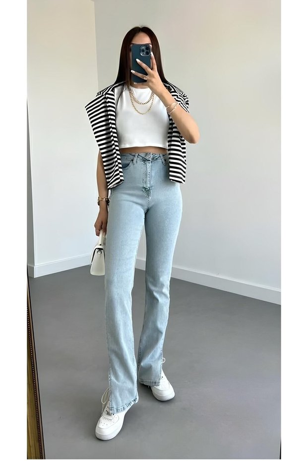Travelista Women's Light Blue Washed Denim Jeans with Side Slits, Spanish Cut, and High Waist.