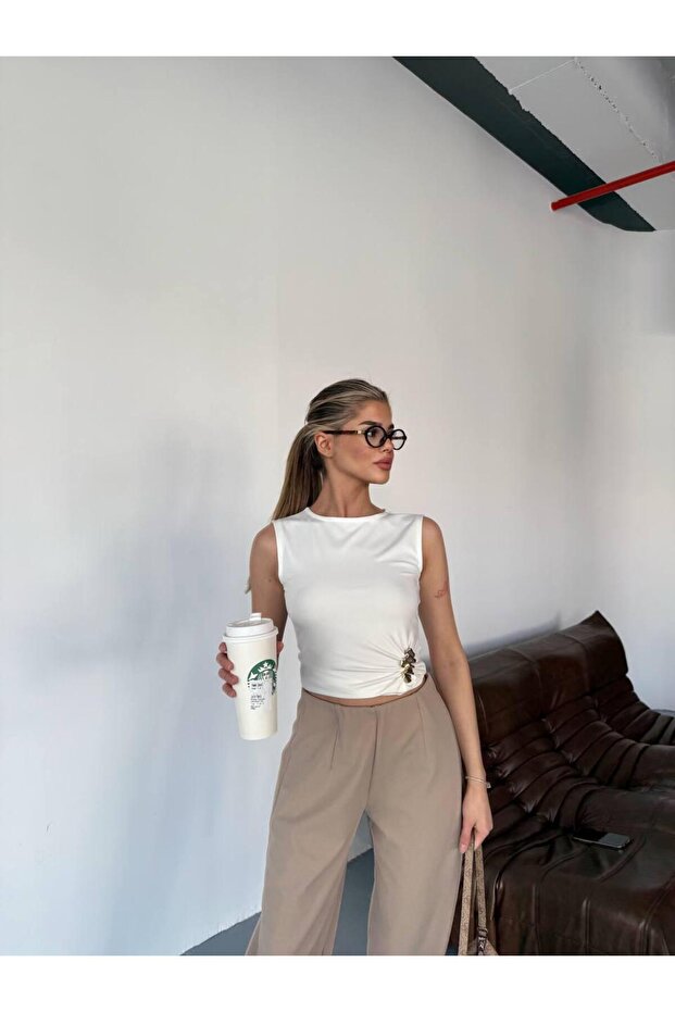 Sleeveless White Draped Blouse with Accessories