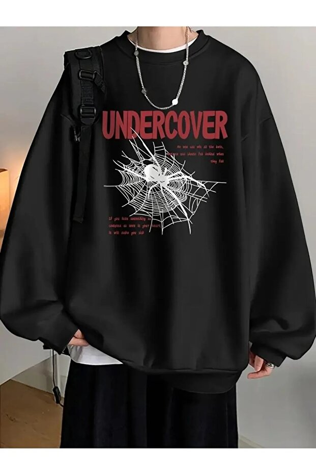 سويت شيرت Undercover مطبوع ذو اللون الأسود وياقة الدراجة