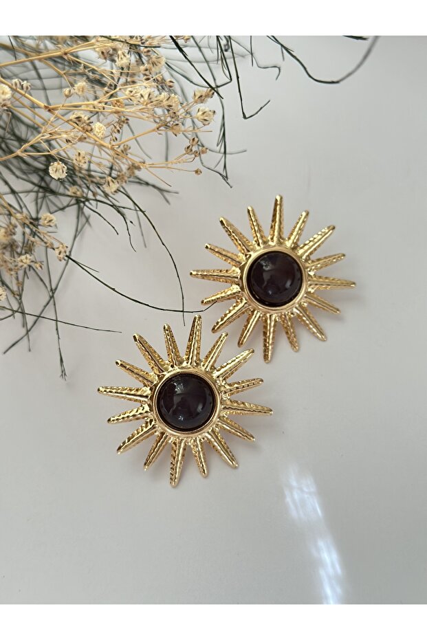 Gold-plated sun earrings with burgundy stone accents.