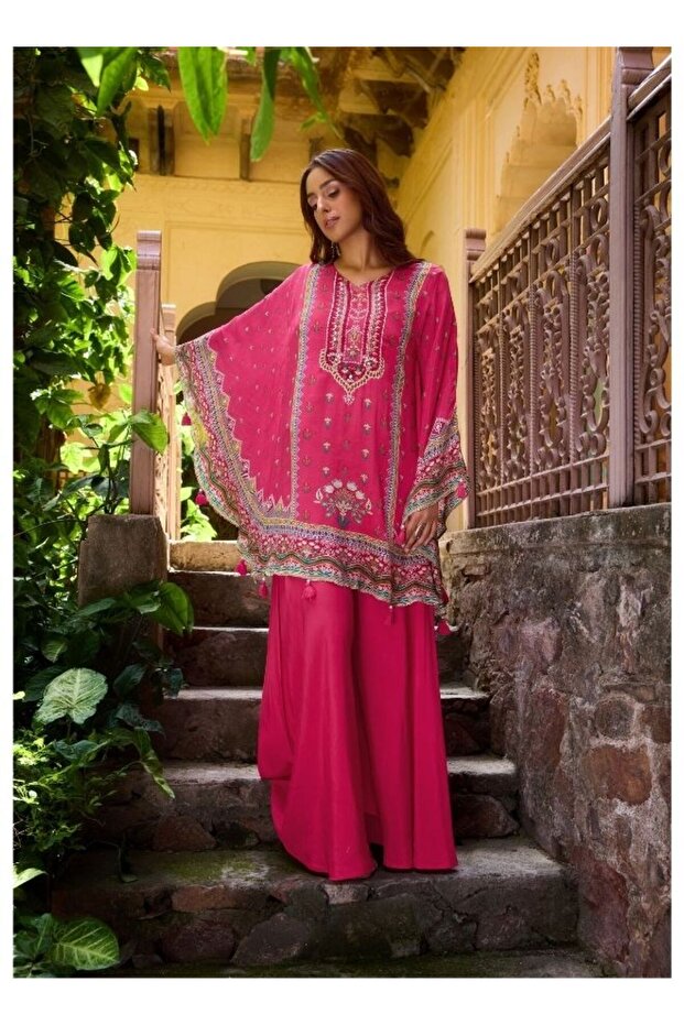 Vibrant Fuchsia Ethnic Wear Against Traditional Indian Architecture