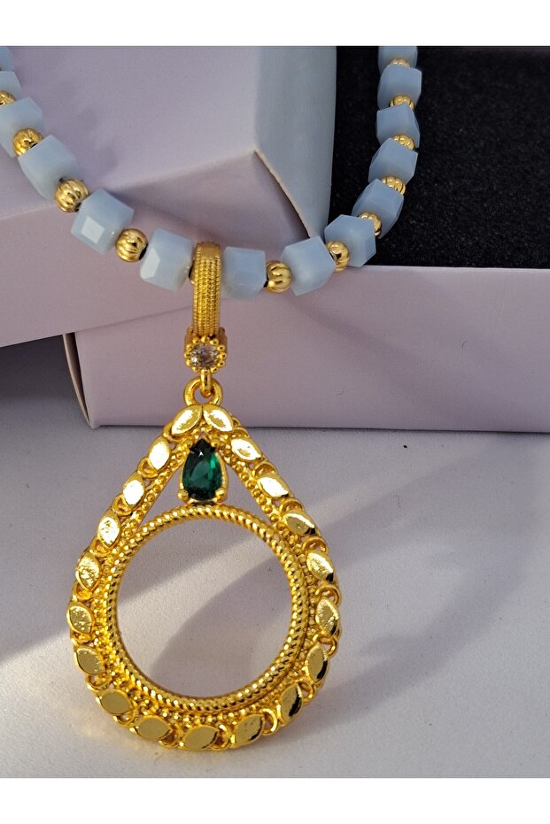 Blue Beaded Green Stone Quarter Pendant That Can Be Attached to a Necklace.