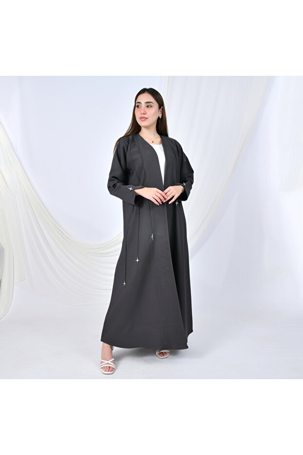 A modern design abaya in gray, adorned with gold buttons in the shape of cascading stars, adding a striking touch. - 1