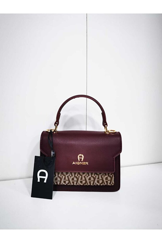 A small burgundy handbag with a partial pattern at the bottom. - 1