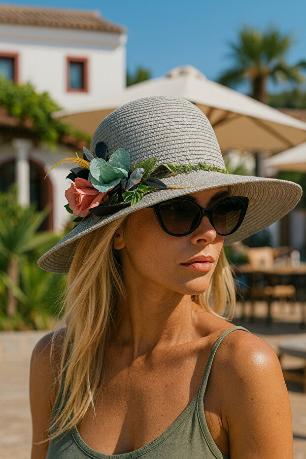 Woman's gray straw hat with floral accessories