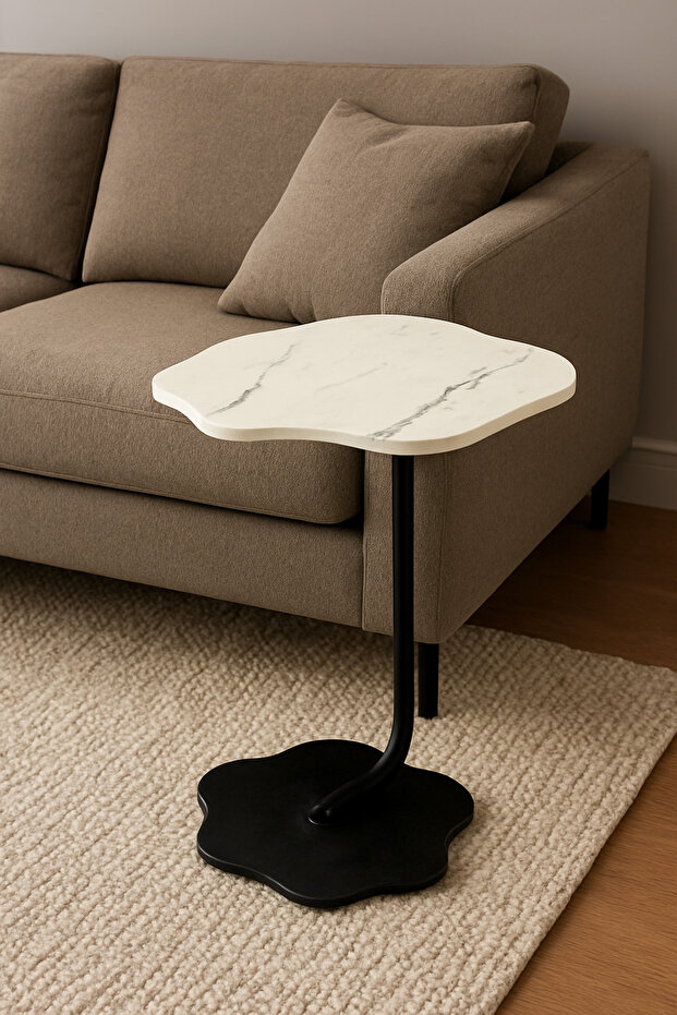 A modern side table with an elegant design and a distinctive flower-shaped top, perfect for living rooms and cafes.