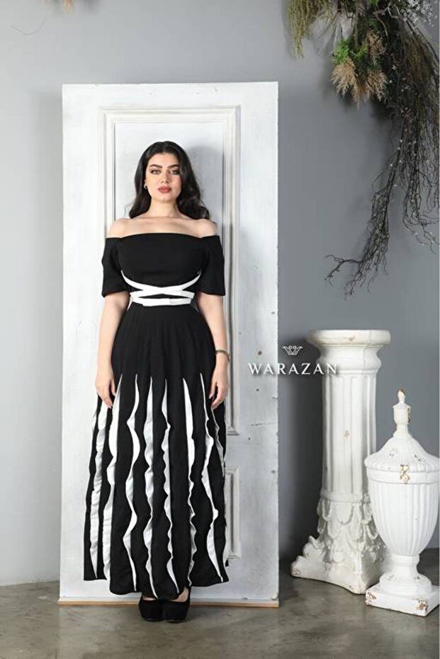 فستان سهرة طويل ناعم أسود اللون مزين بالكشكشة البيضاء