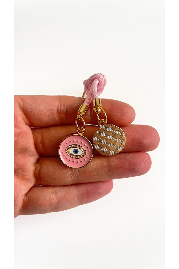 سلسلة مفاتيح على شكل عين دائرية باللون الوردي الفاتح - 6