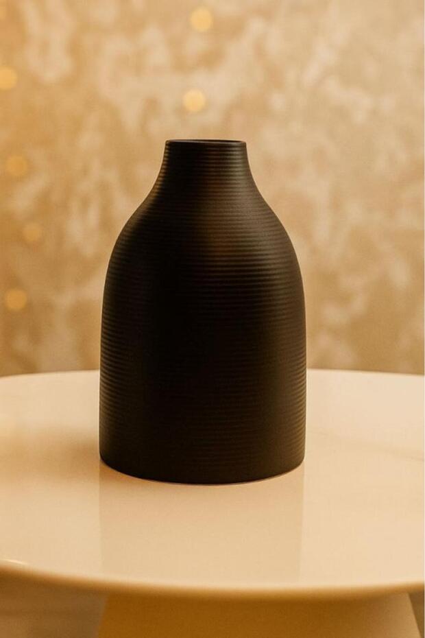 A luxurious black vase with a modern, streamlined design.