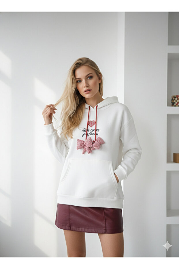 Women's three-thread soft touch long sleeve sweatshirt with pocket detail, drawstring tie, and embroidered bow accent.