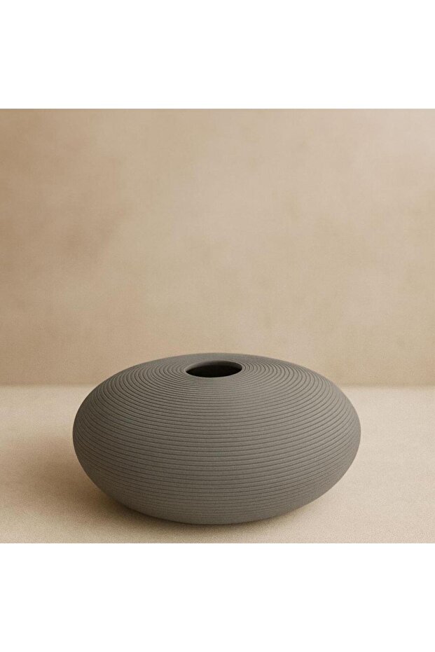 A round, gray, striped vase for modern decor