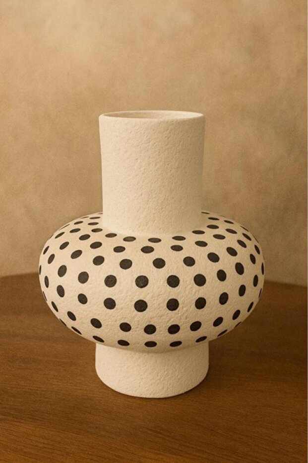White ceramic vase with black polka dot pattern, modern design for interior decoration