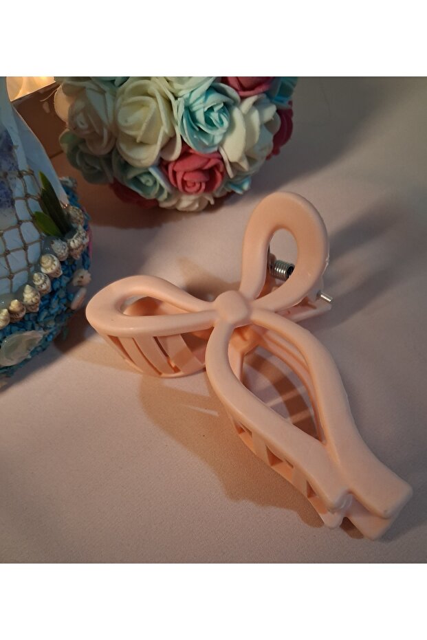 مشبك ملابس برتقالي بتصميم فيونكة - 1