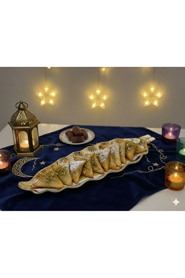 A ceramic serving dish in white and gold, measuring 35x13 cm, suitable for Ramadan.