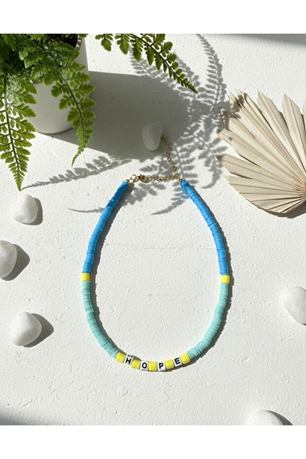 Blue and Yellow Fimo Necklace with the Words'Hope' Written on It