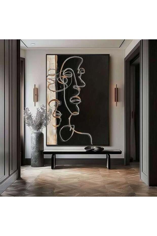 وحة فنية تجريدية بتصميم وجه مرسوم بخطوط انسيابية دقيقة، يتناغم فيها اللون الأسود العميق مع لمسات ذه