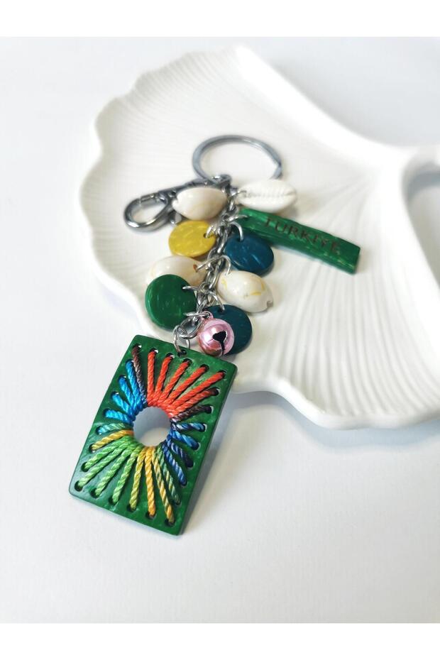 Green rectangular figure keychain charm with turkish writing