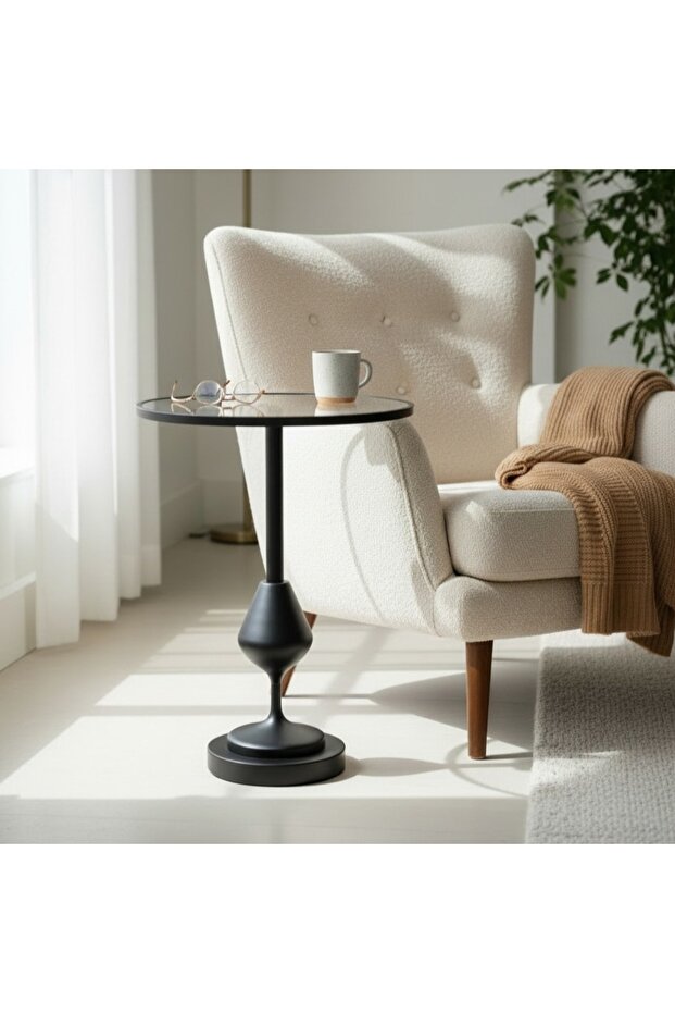 Modern round side table with a black metal base