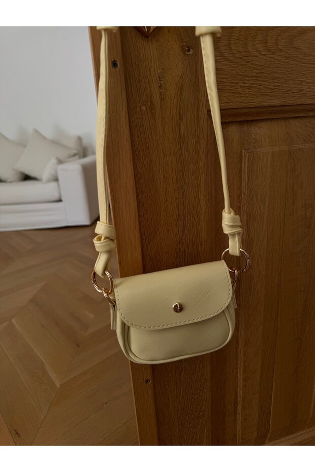 Yellow mini bag with knotted strap and lid