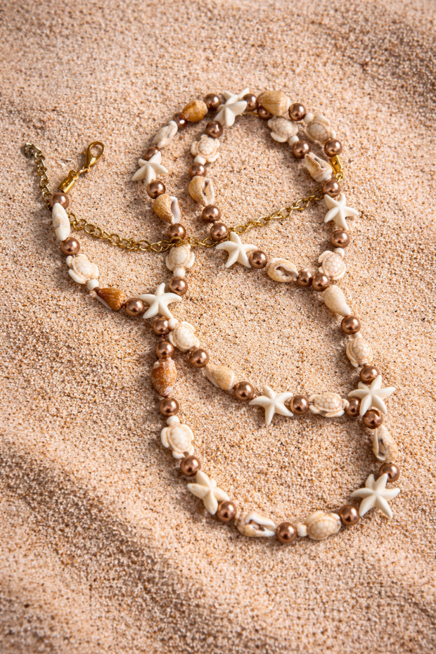 Beach-themed waist necklace belt accessory designed with real seashells.