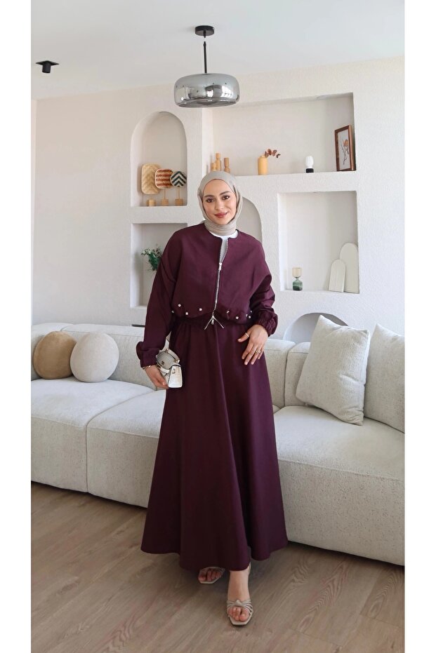 Bomber jacket and skirt set with stone embellishments.