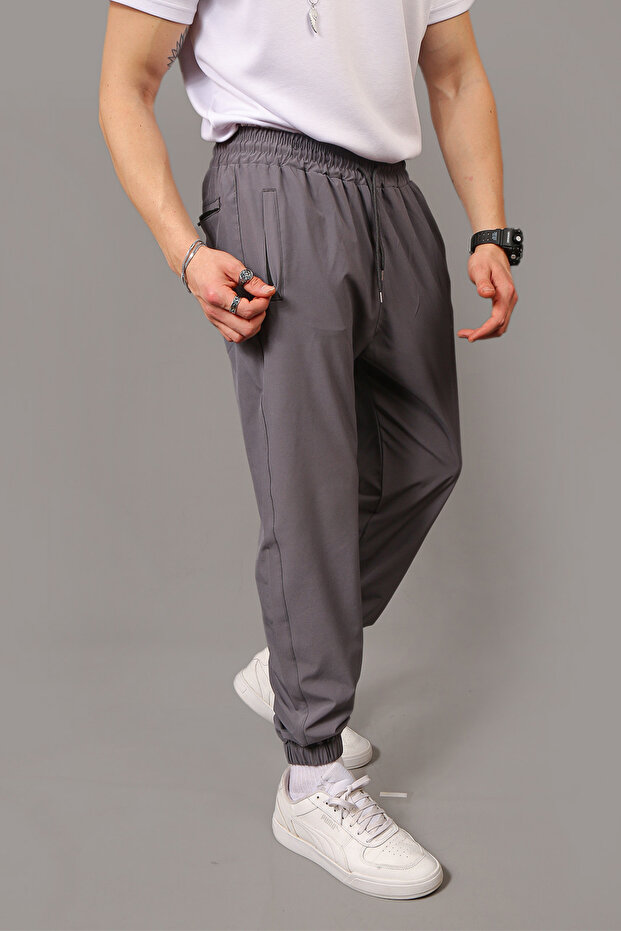 Men's Baggy Style Parachute Fabric Sweatpants with Zippered Pockets and Elastic Cuffs