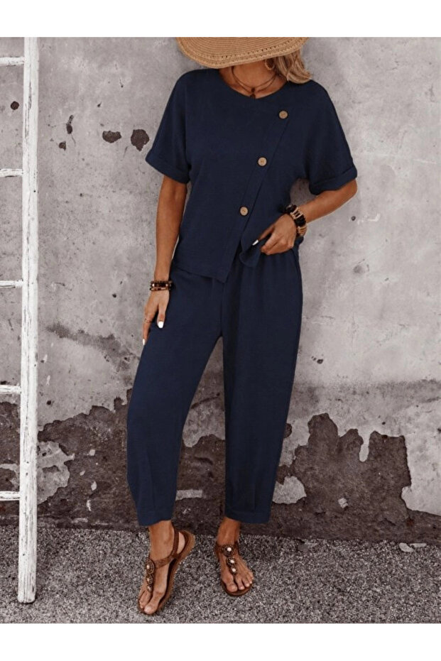 Women's short sleeve asymmetrical cut detailed buttoned ruffle blouse and pants two-piece set