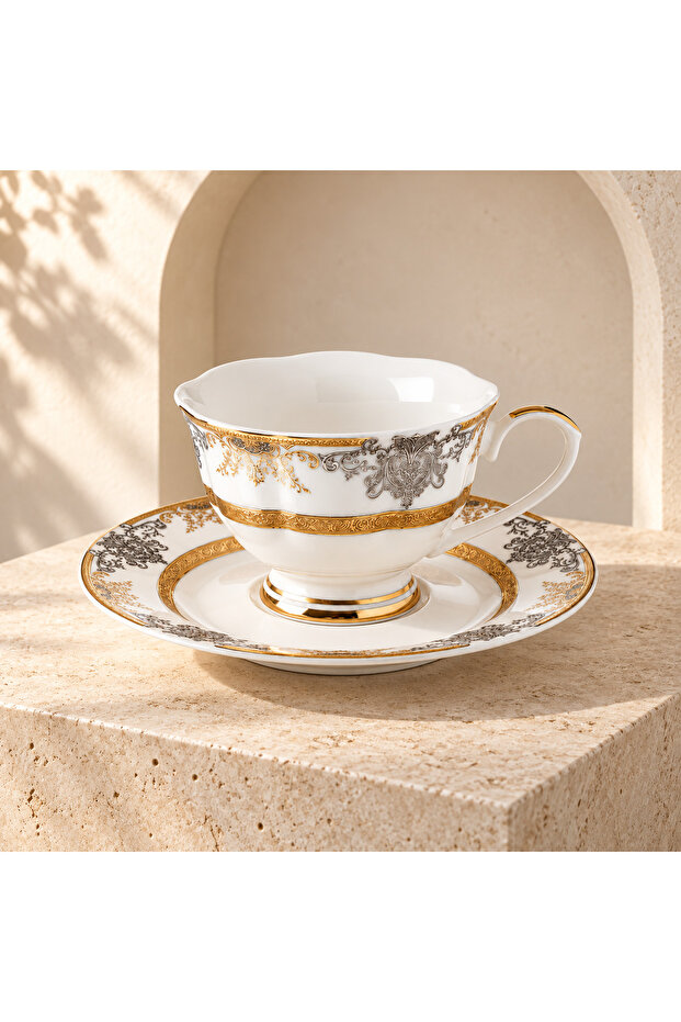 Shiny gold and silver tea cup and saucer set