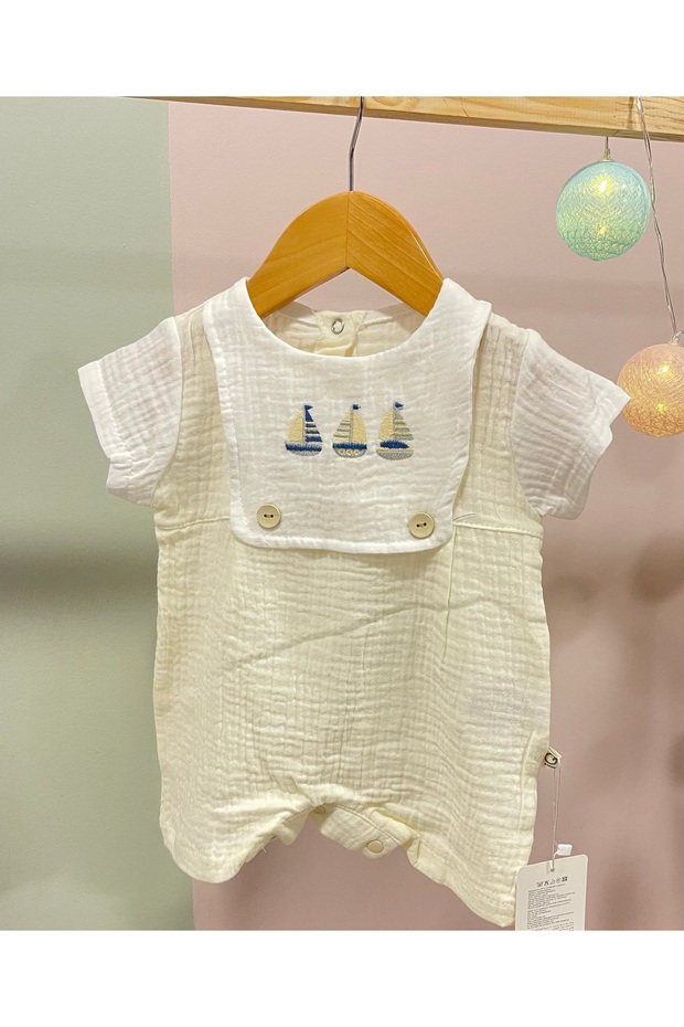 Baby Boy Romper Made of 100% Cotton Muslin Fabric with Sailboat Embroidery and Apron Detail.