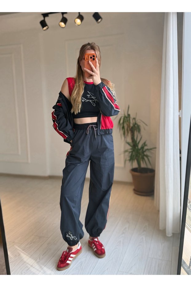 Navy blue elastic waistband side stripe detailed embroidered parachute fabric sweatpants