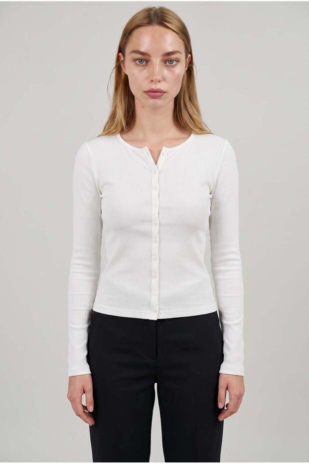 Women's white ribbed knit button-down cardigan blouse with flexible button detail, long sleeves, and crew neck.